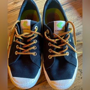 Black canvas sneakers with extra laces and insoles.